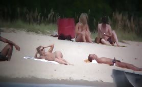 Nude couples chilling on nudist beach